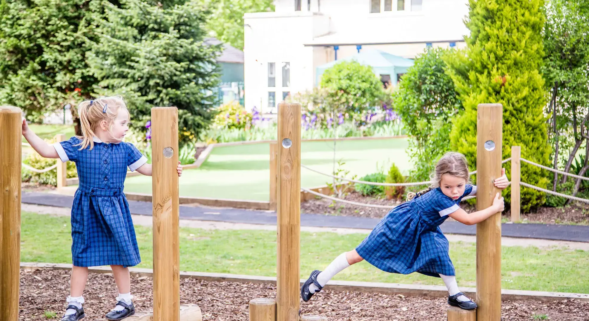 Students traverising playground equipment