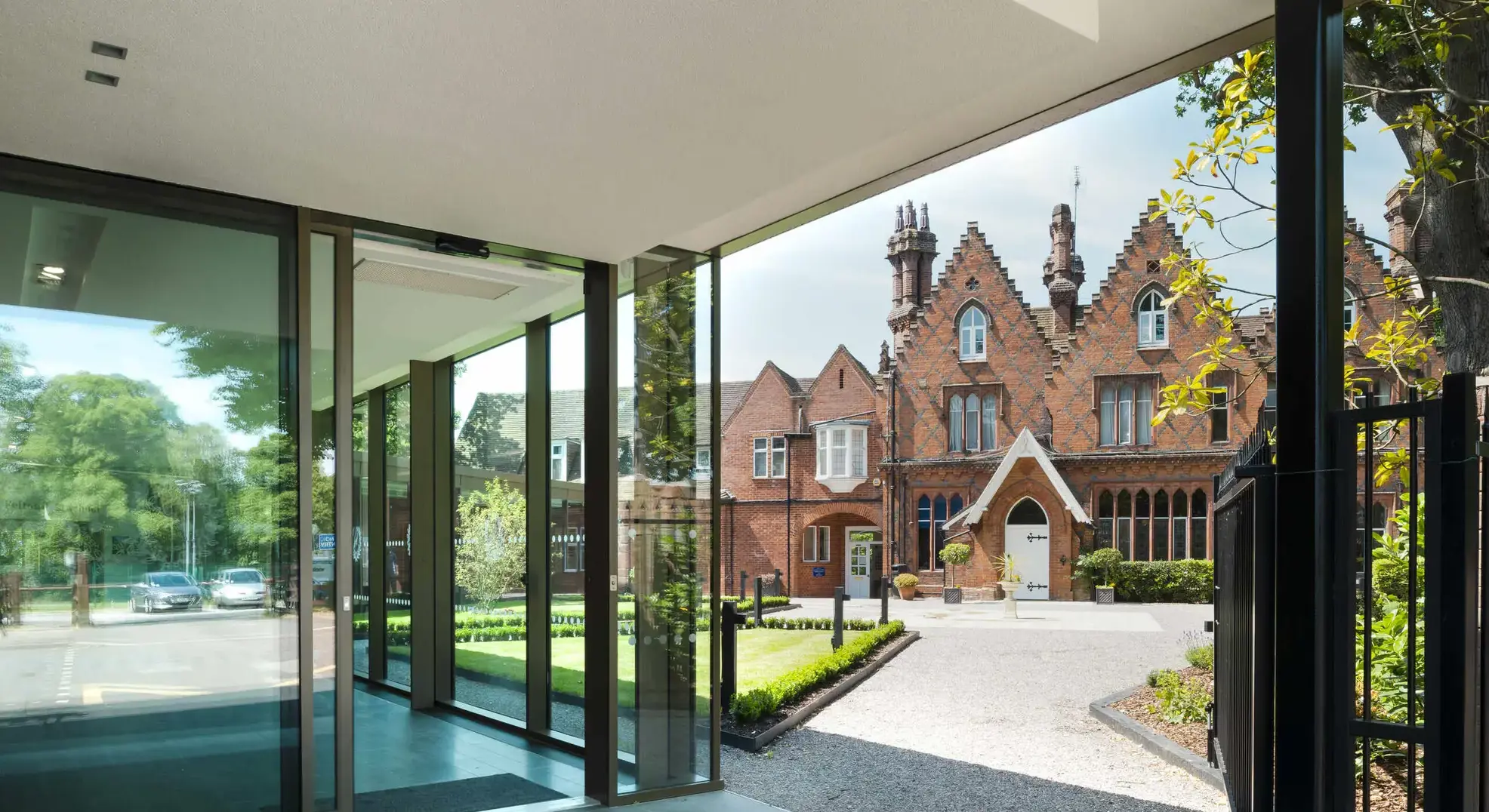 Floor-to-ceiling doors open to reveal Feltonfleet's main building across a field