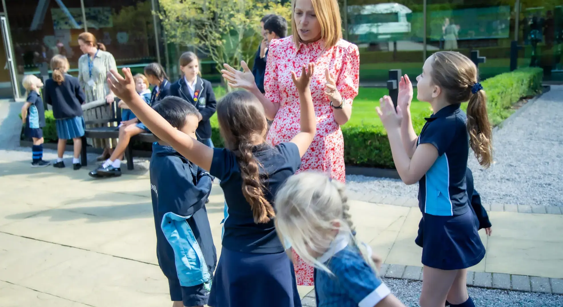 Headmistress chatting with pupils outside