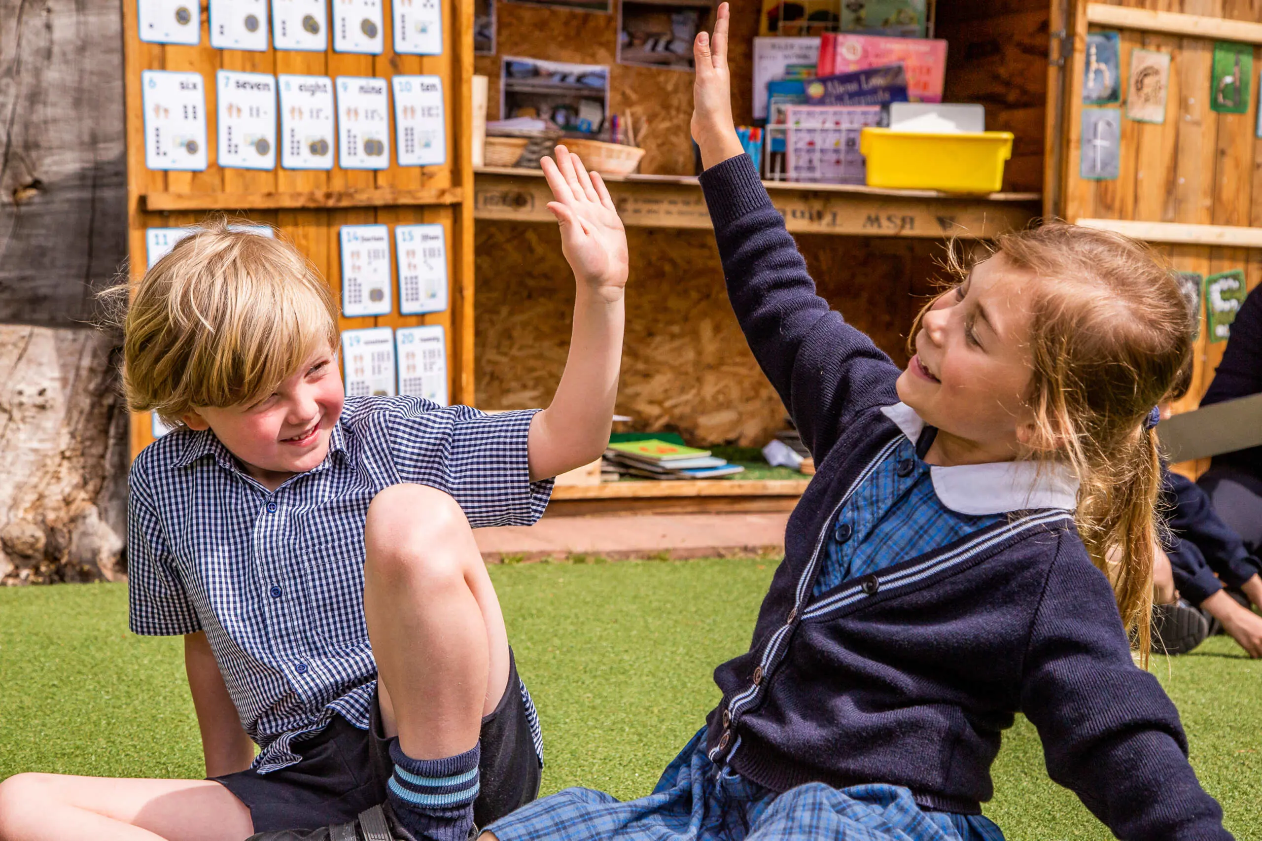 Two students high-fiving