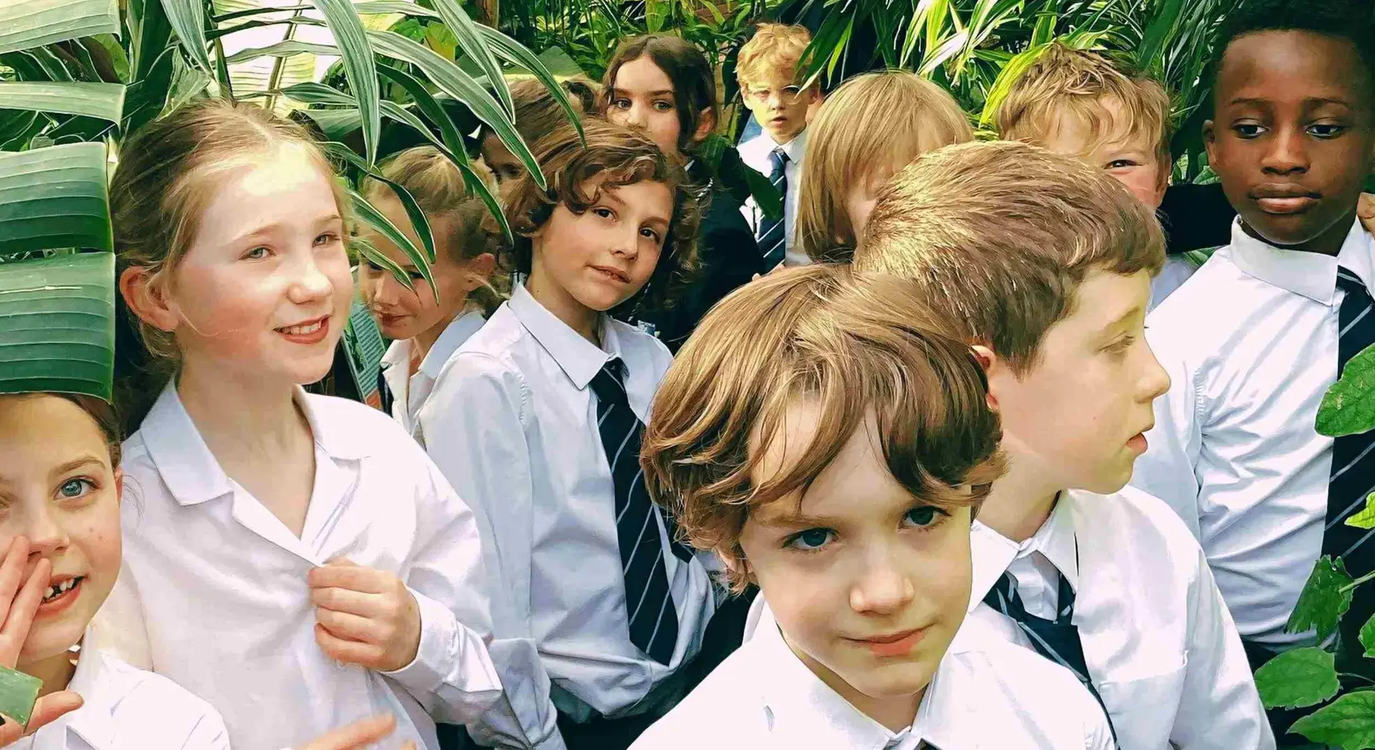 Group of students surrounded by foliage