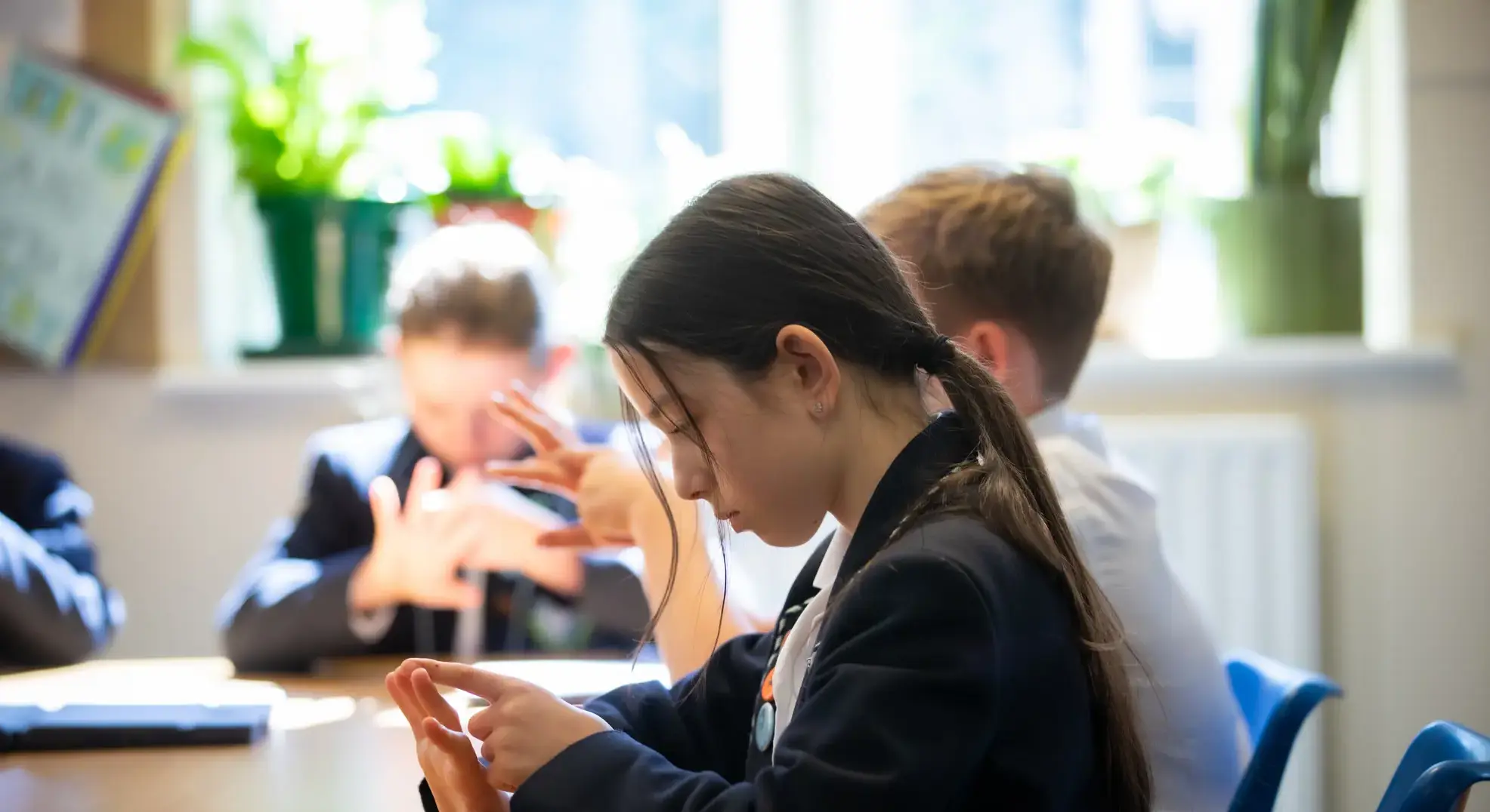 Students tracing hands in lesson