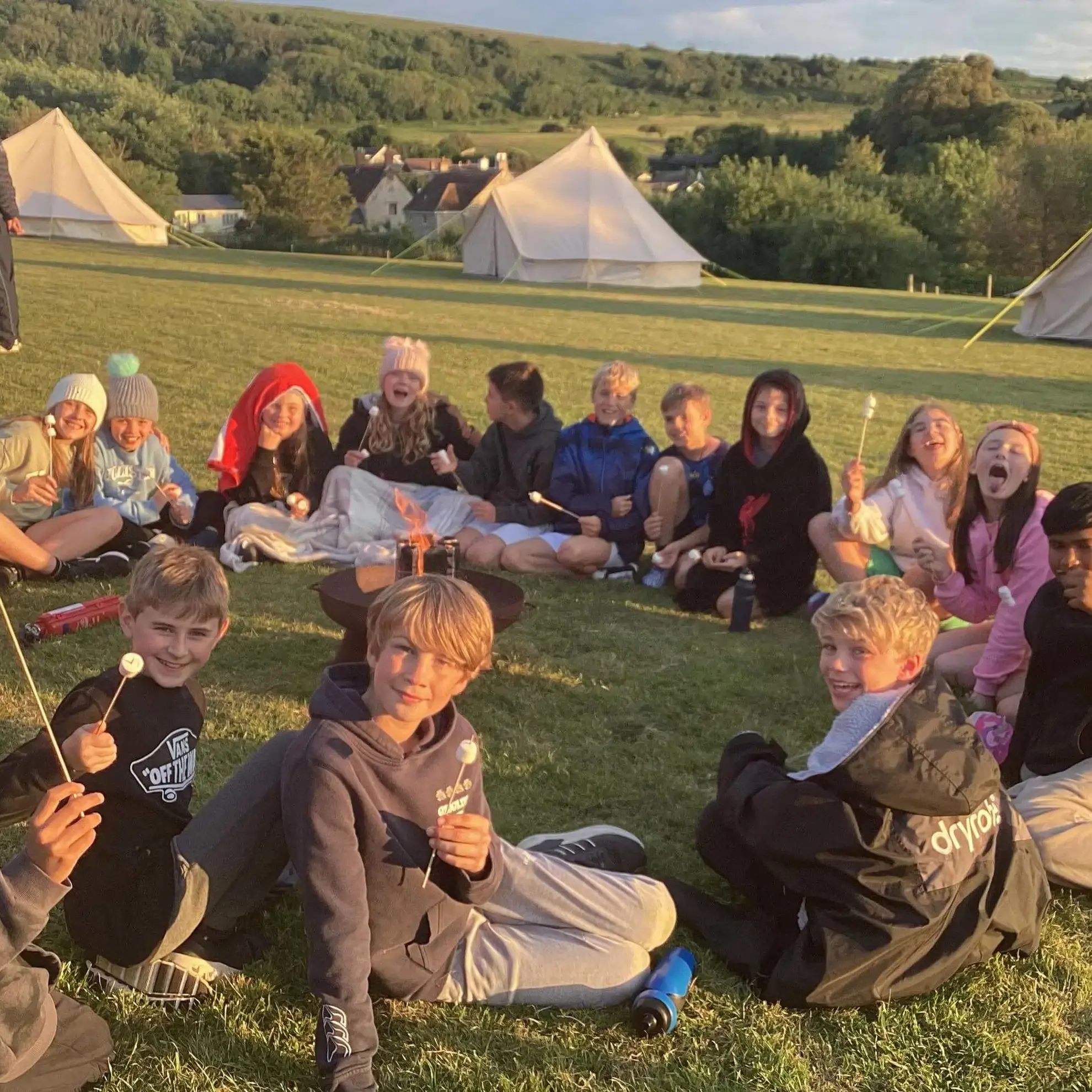 Students sitting around campfire