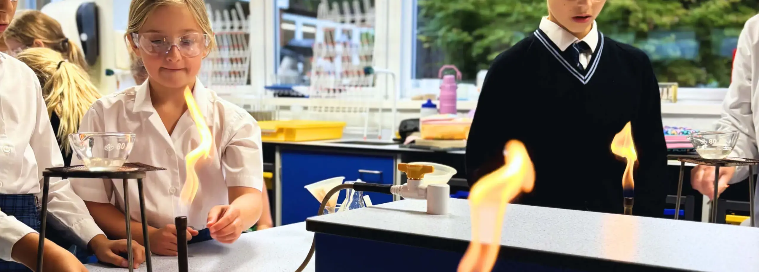 Middle School Pupils using Bunsen burners in Science experiment Feltonfleet Private School Surrey
