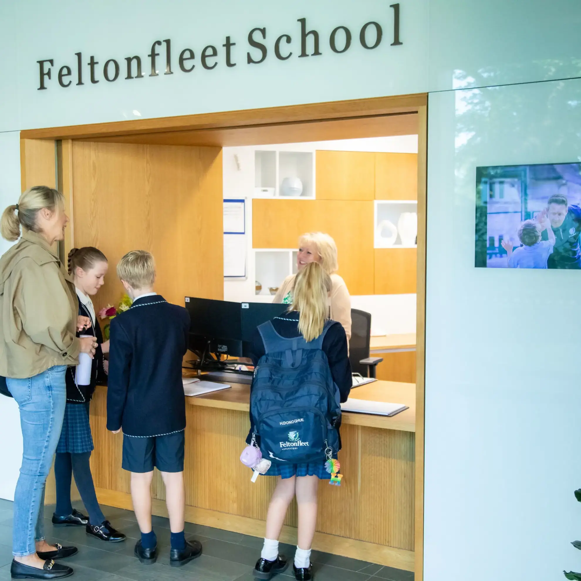 Parent speaking to receptionist at drop-off
