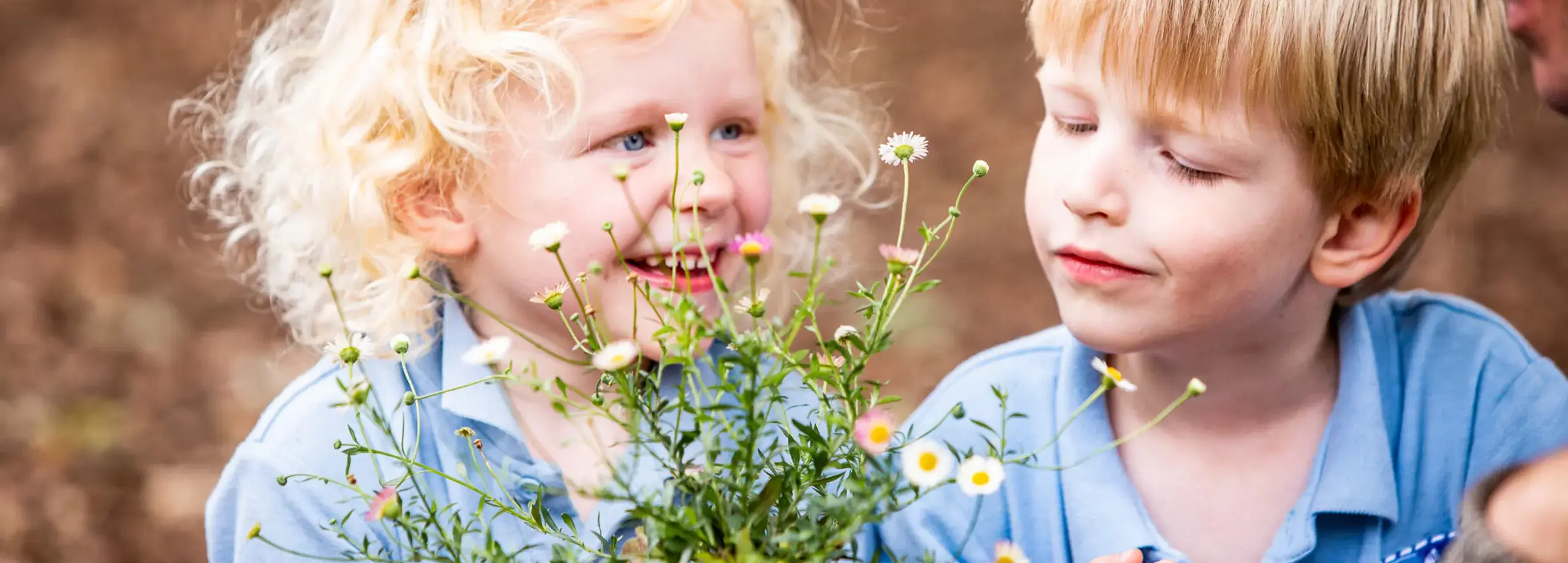 Nursery pupils enjoying gardening Feltonfleet Private School Surrey