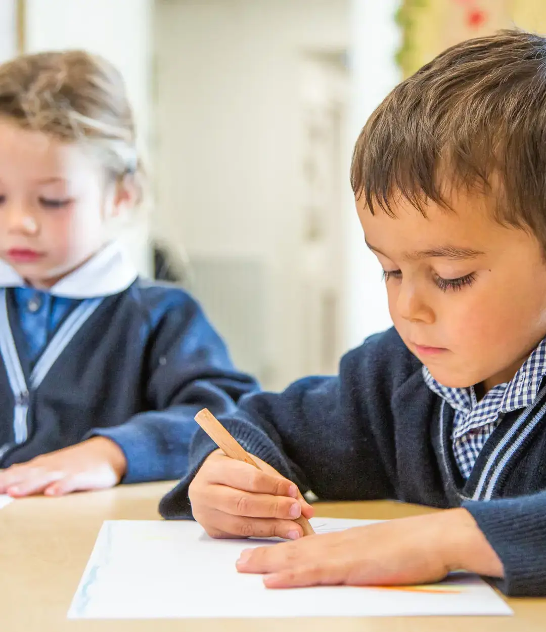 Nursery students practising gripping pens