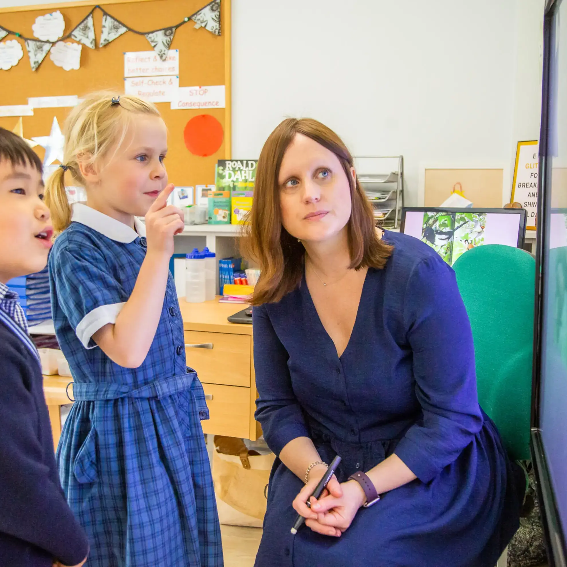 Students and teacher looking up at something out of shot