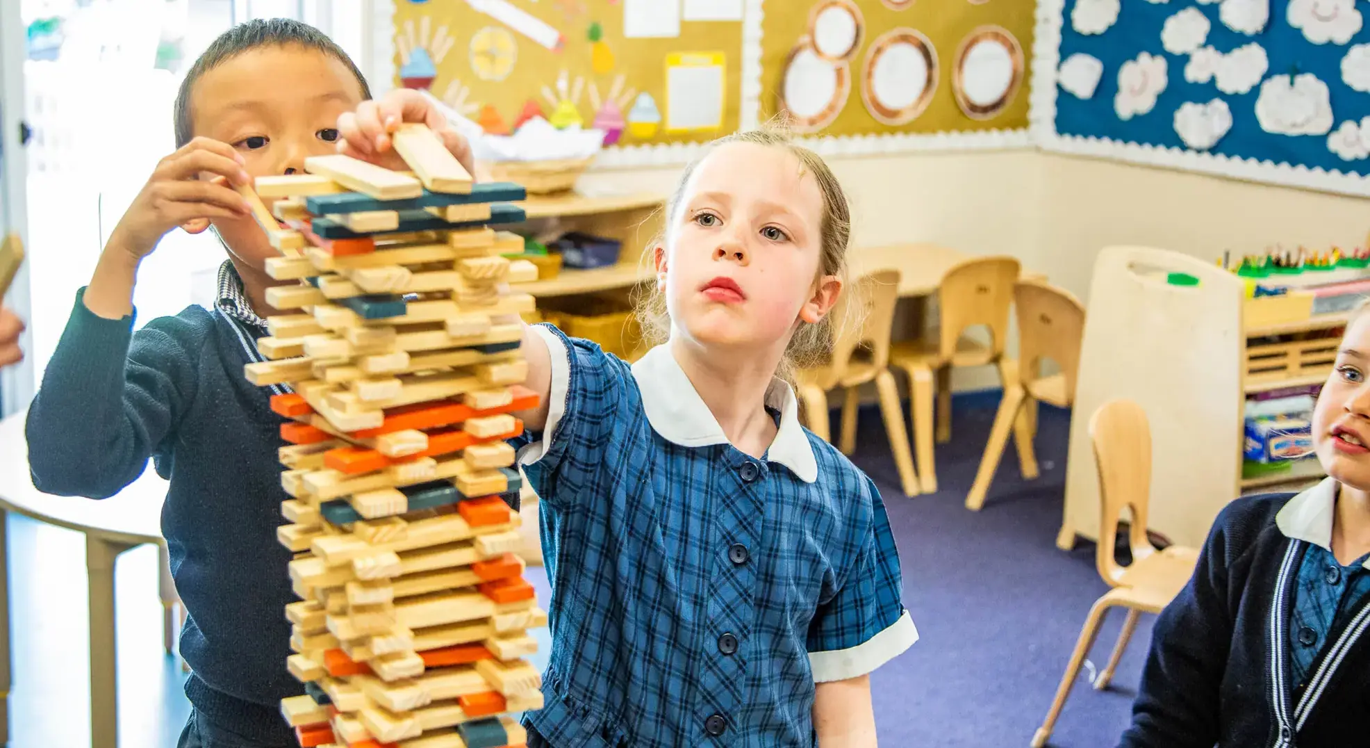 Students constructing Jenga-like tower from sticks Feltonfleet Co-curricular Private School Surrey