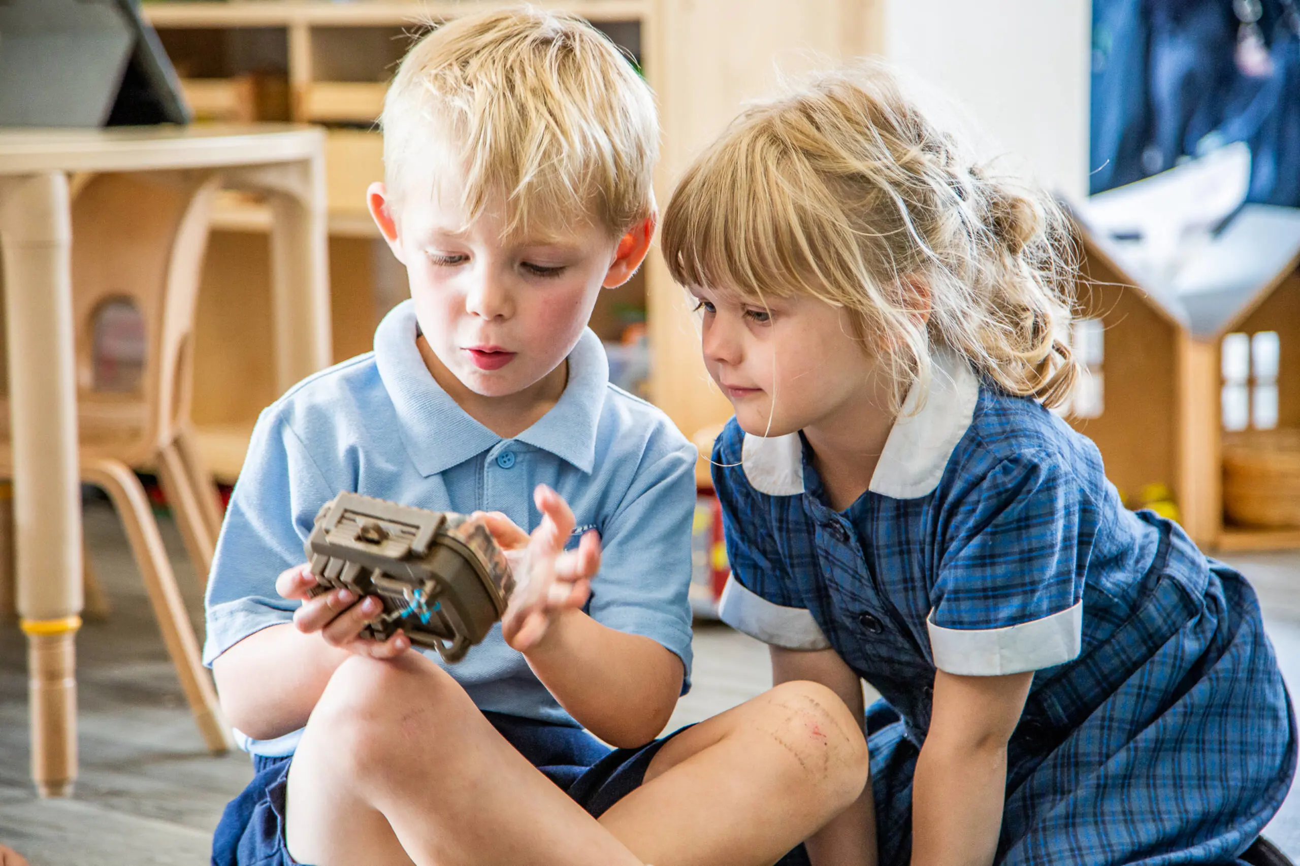 Two students investigating an object