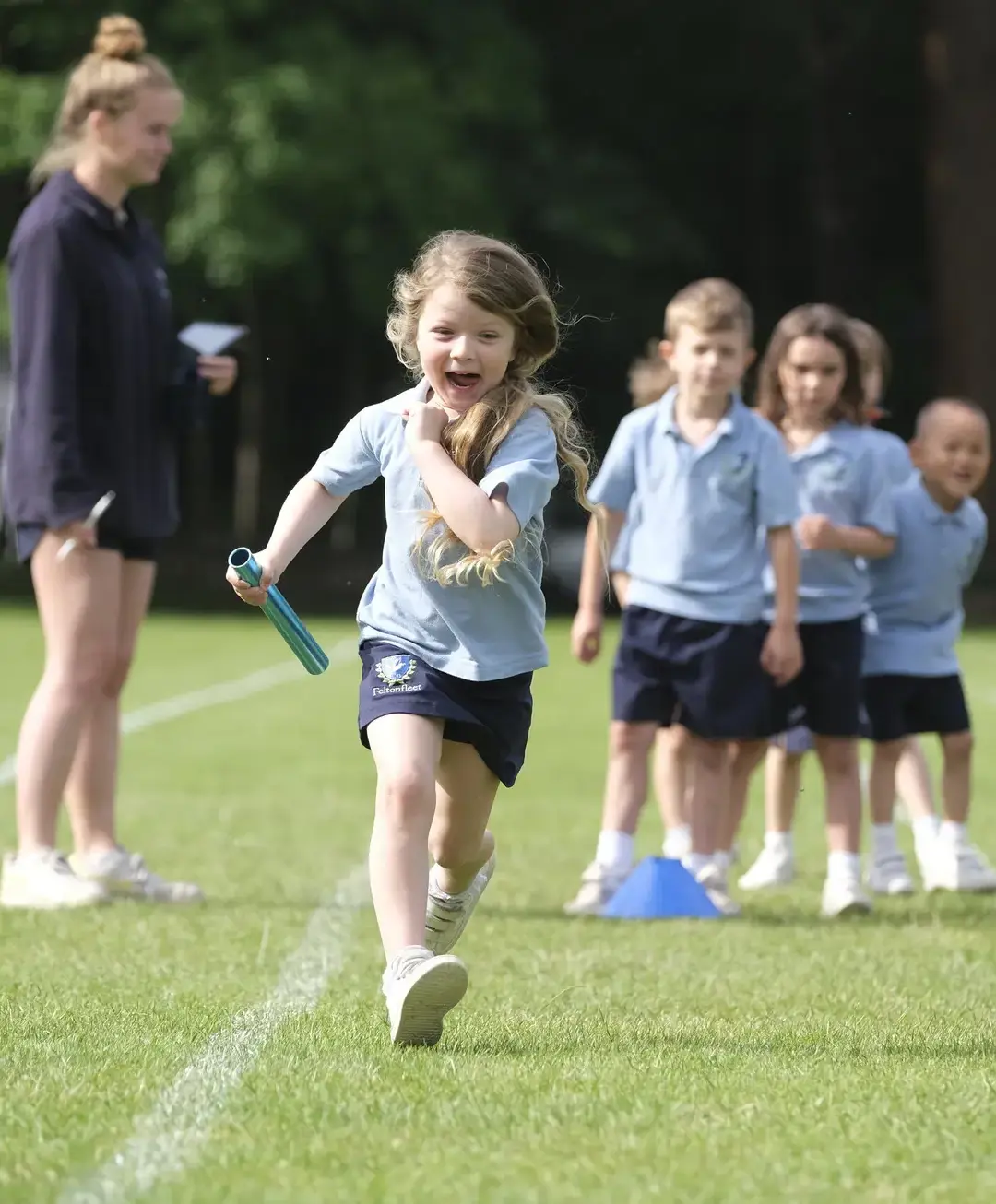 Student running relay, holding baton