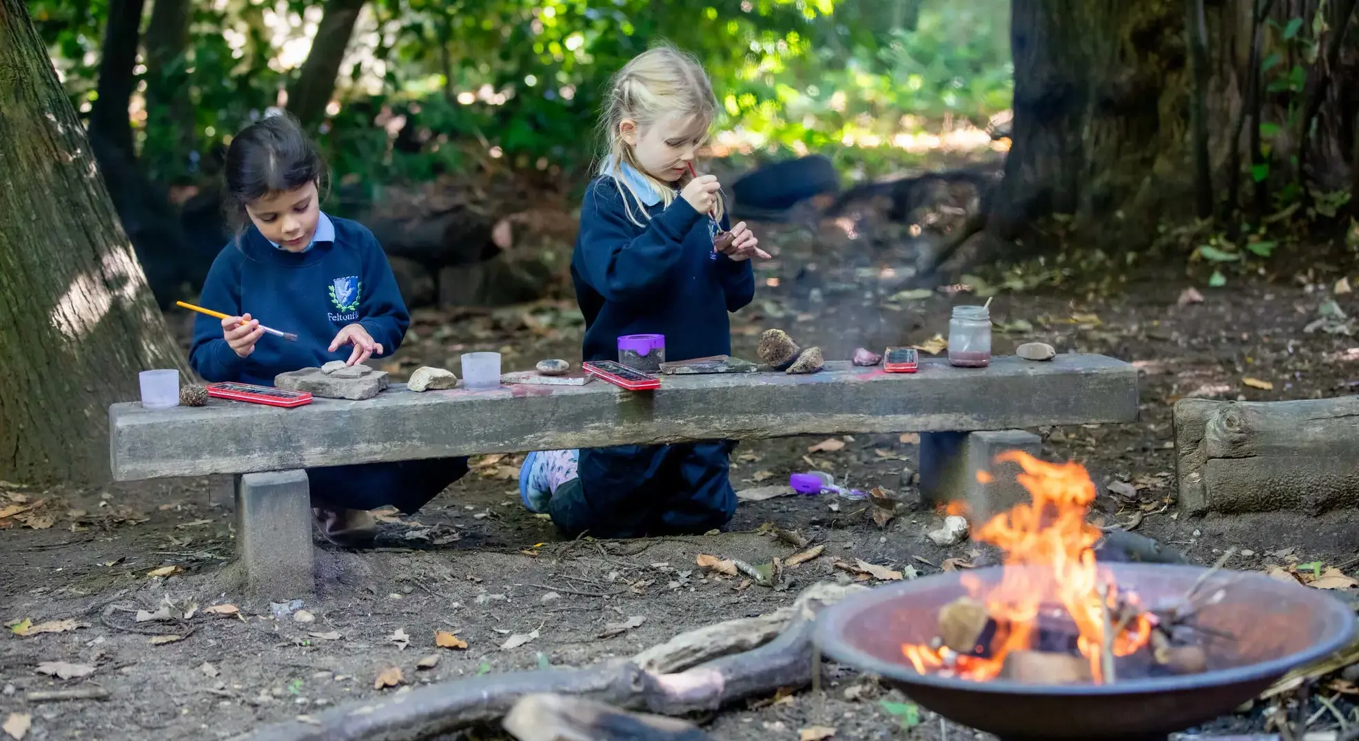 Students sitting by a campfire