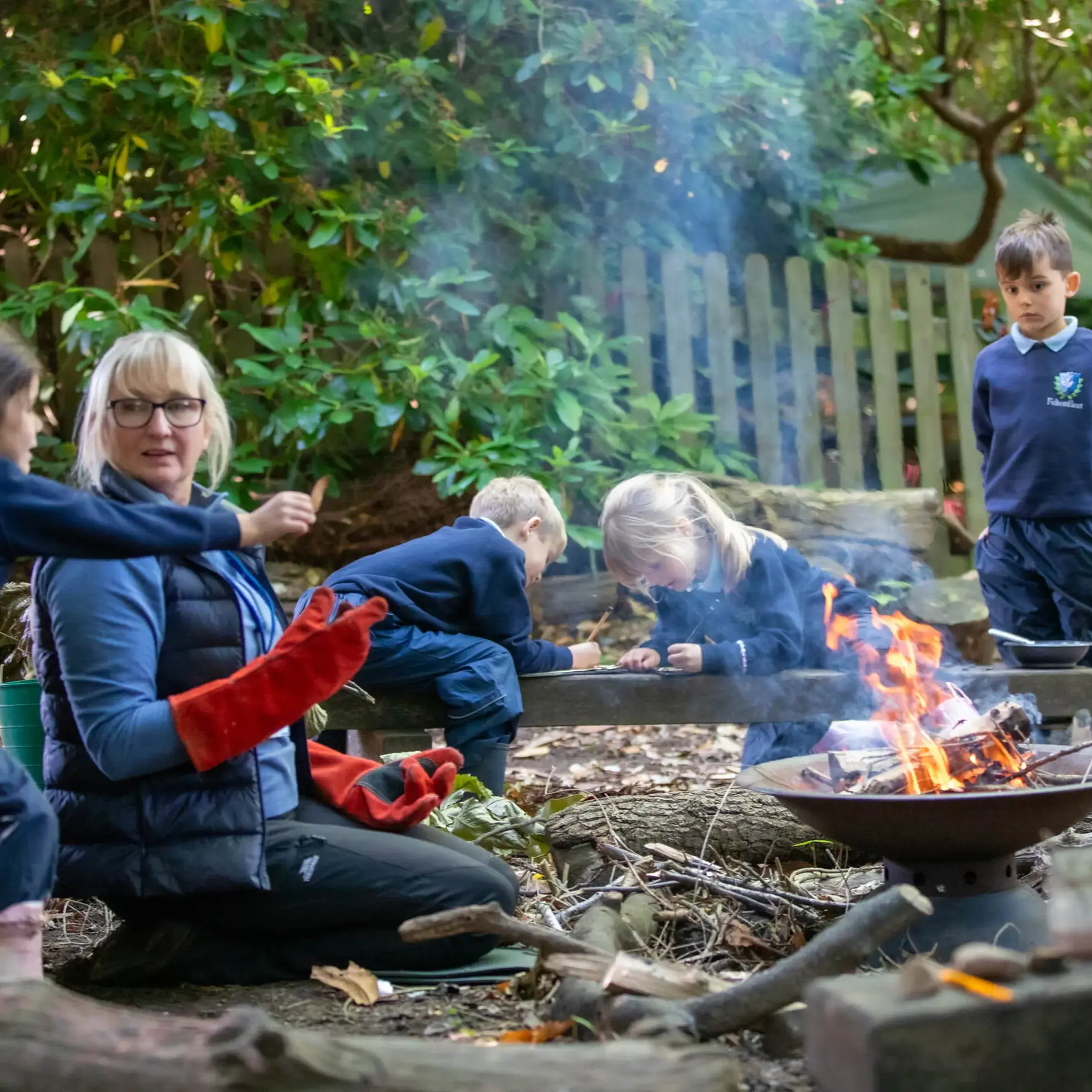 Teacher and students around a campfire