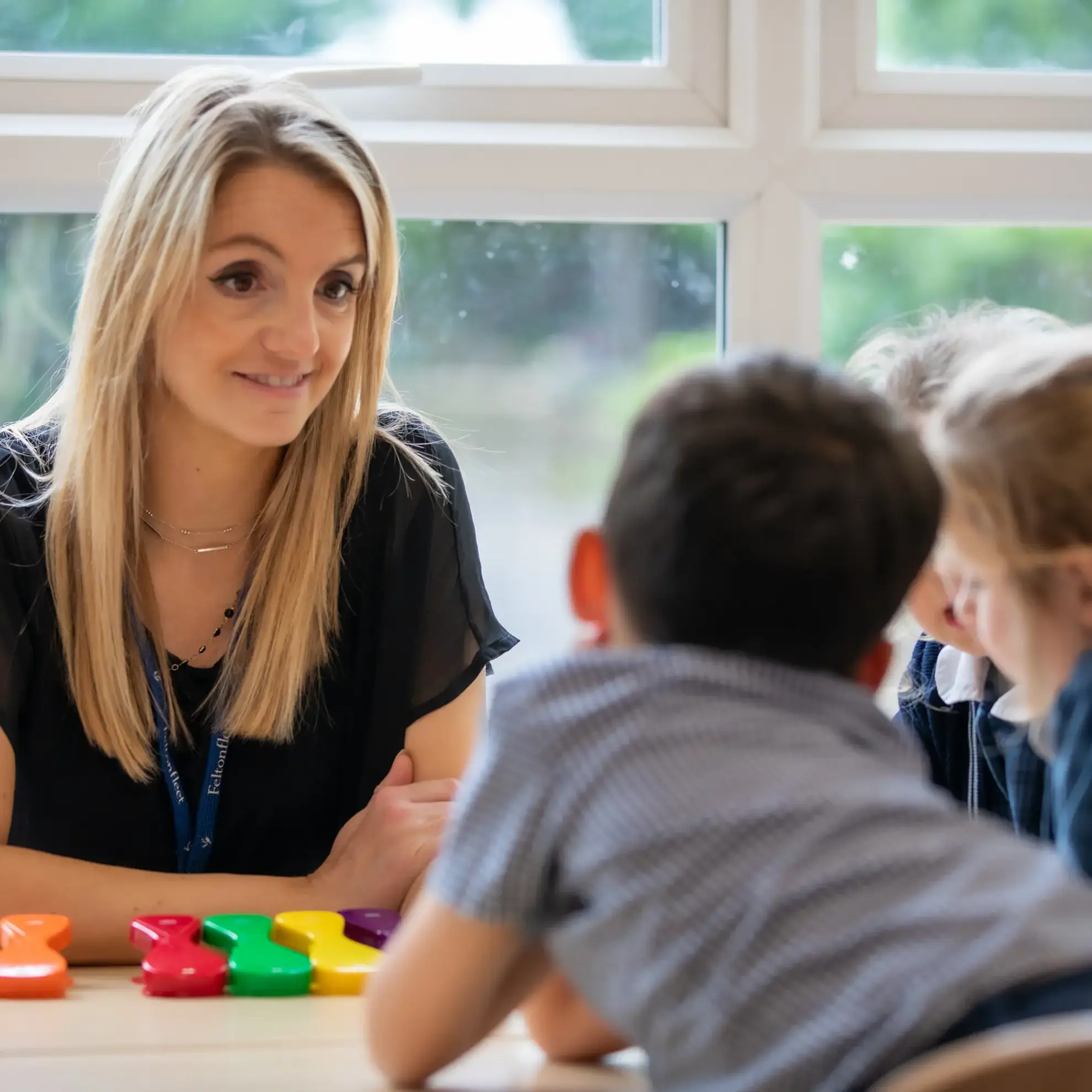 Teacher sitting with students