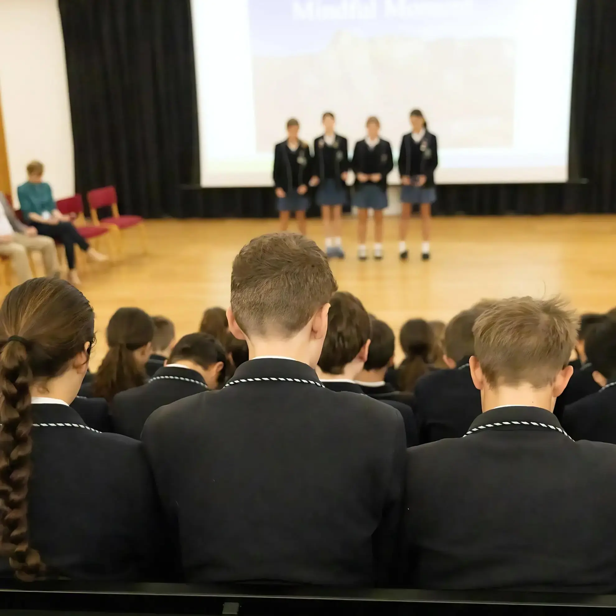 Students giving presentation in assembly