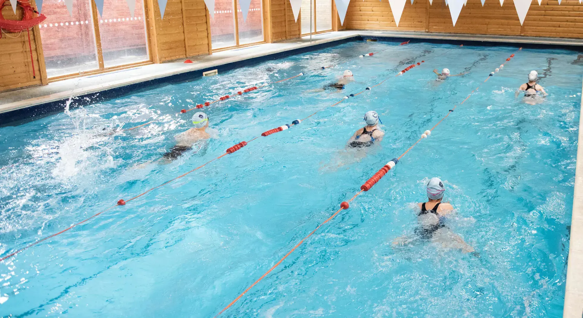 Students swimming in indoor pool