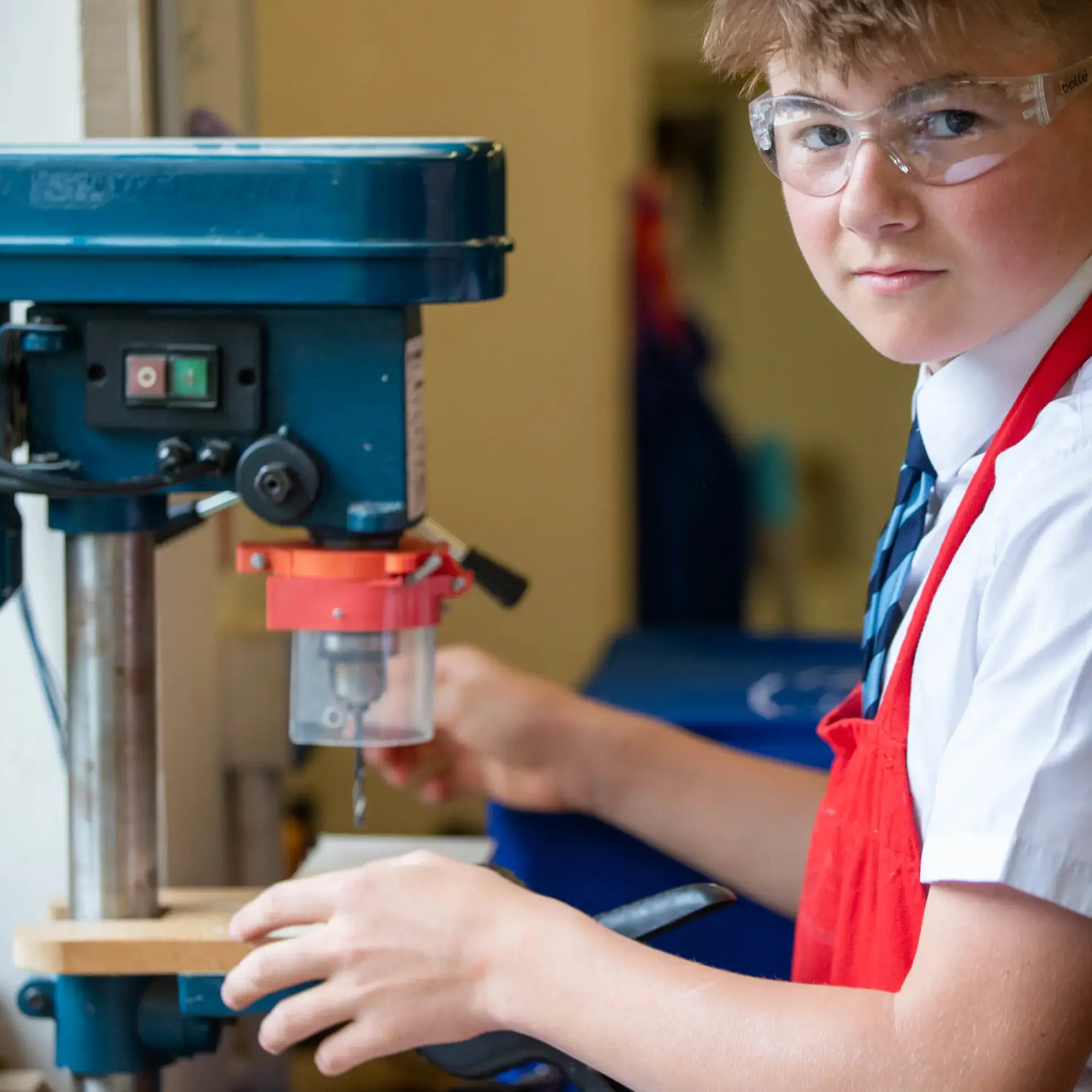 Student using a hand drill