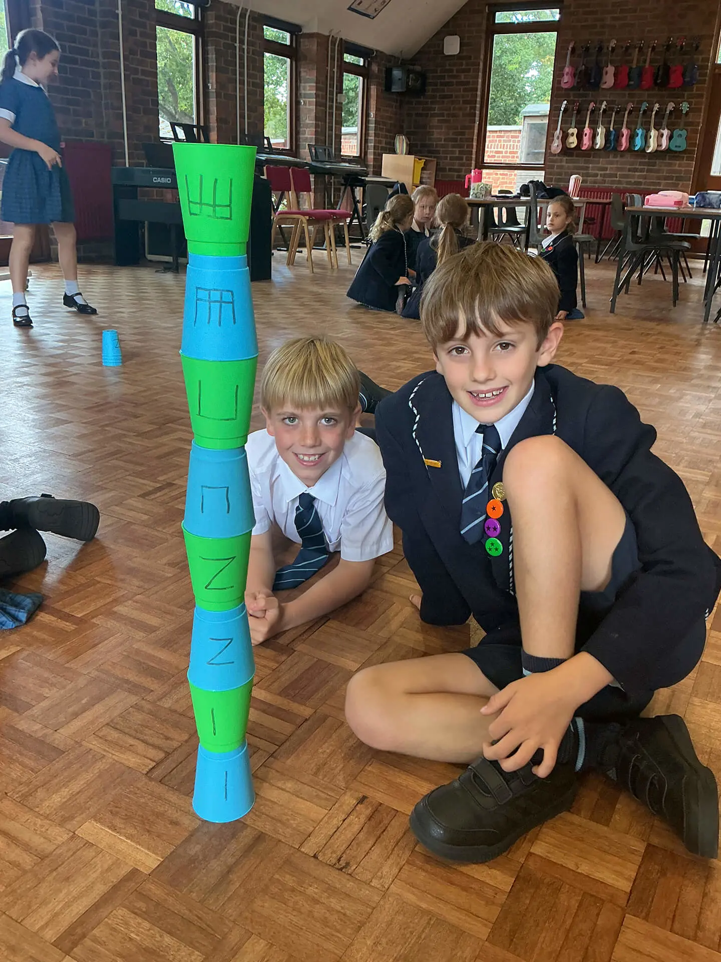 The Feltonfleet Music curriculum is based on the philosophy of Zoltán Kodály, a Hungarian composer, educator and musicologist. Kodály noticed that lots of children were leaving school unable to sing in tune and with no real understanding of the music that they were playing. He developed a new system of teaching music, a method that is now used all over the world. Kodály travelled the world to find the best teaching tools. His method uses solfa, developed by Sarah Glover in the UK, hand signs created by John Curwen in the UK, rhythm syllables, developed in France by Galin, Paris and Chevé and child development theory based on the workings of  the educators, Pestalozzi and Piaget, both from Switzerland. All Kodály lessons include lots of games. They are rigorous but also fast-paced and fun. Here are some pictures of year 4 taking part in a rhythm-building exercise.