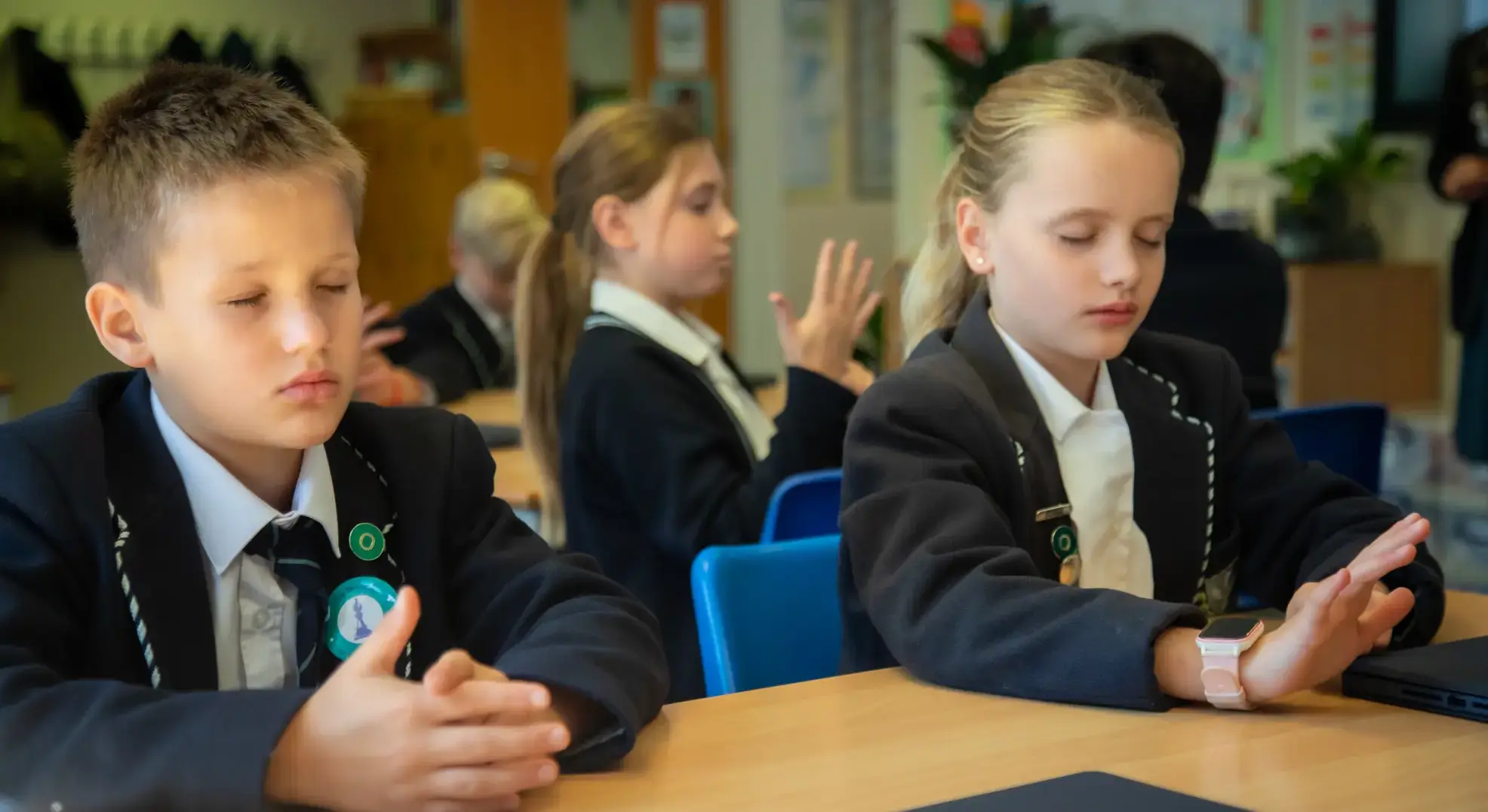 Students tracing their hands with their eyes closed