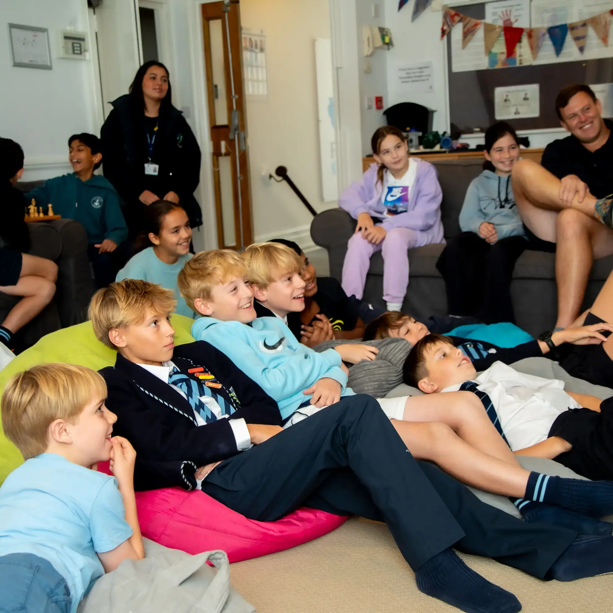 Students lounging on the floor watching a film