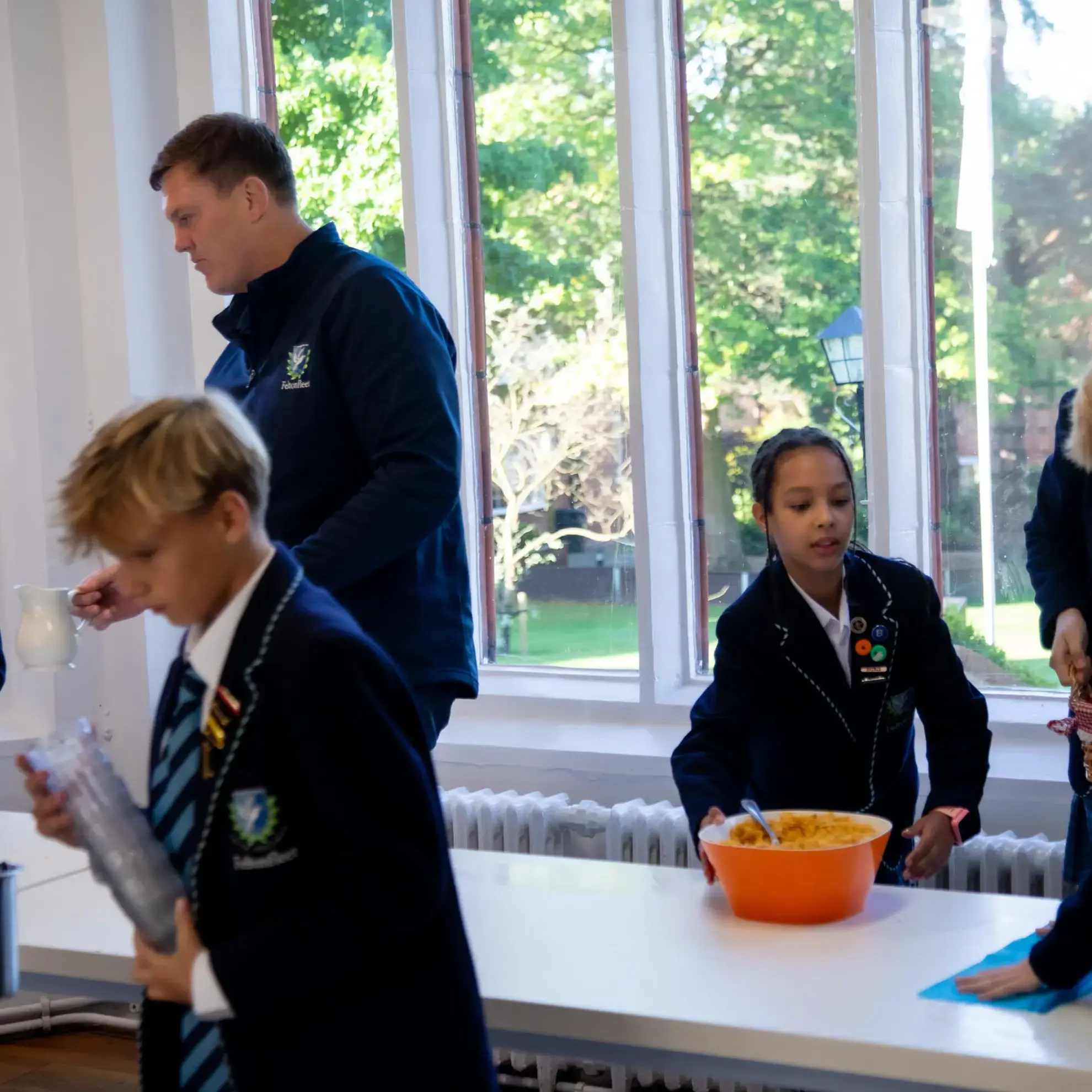 Students clearing breakfast away