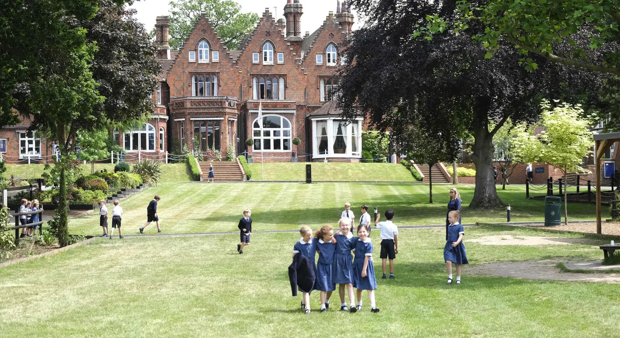 Students walking on a lawn outside school